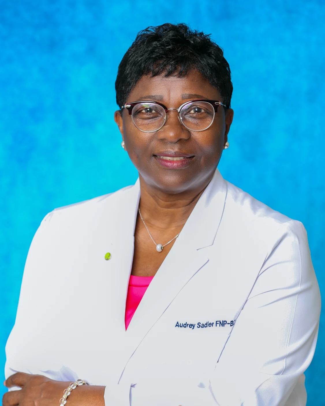 Audrey Sadler, FNP-BC, in a white clinical coat